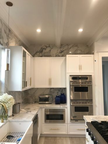 A picture of a luxurious kitchen with white interiors 