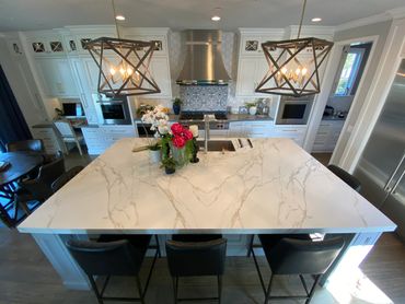 A picture of a white marble table with flowers