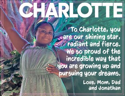 Young girl in a green dress smiling joyfully with a heartfelt message from her family.