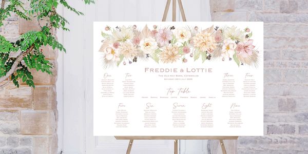 Wedding seating chart with floral design on an easel.