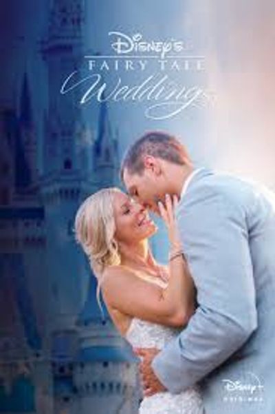 A couple lovingly embraces in front of a Disney castle for their fairy tale wedding.