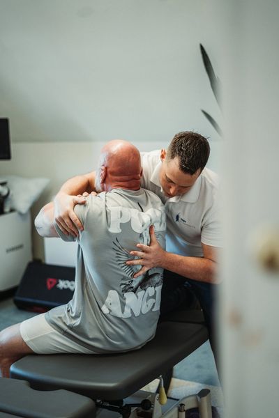 Chiropractor providing hands-on treatment to relieve a patient’s lower back pain in Tenby