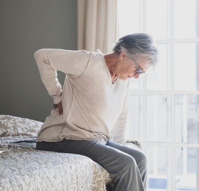 Person being treated by a chiropractor for arthritis-related back pain in Tenby, Pembrokeshire.