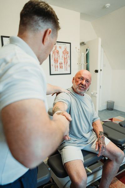 Chiropractor assessing shoulder, hip, knee, ankle and wrist pain and providing treatment - Tenby,