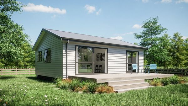A small modern house with a deck and outdoor chairs.