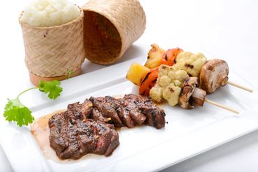 A plate of beef steak and grilled veggies