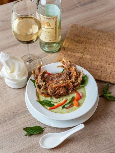 A plate of grilled crab with green thai sauce 