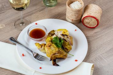 A plate of chicken wings with hot sauce and wine 