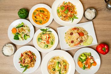 A Bunch of Plates With Thai Dishes