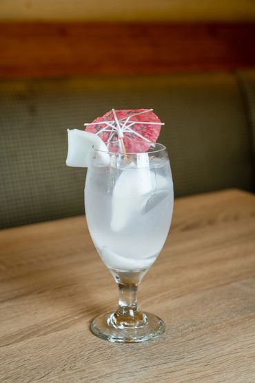 A Glass With A Drink On A Surface