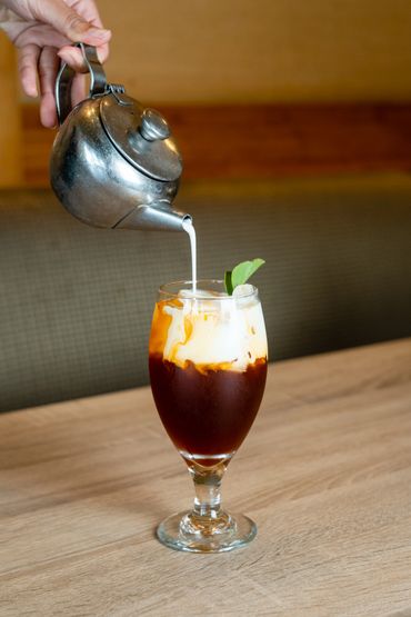 A picture milk pouring into the chocolate latte