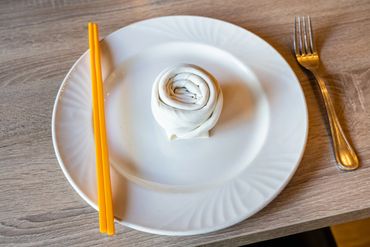 A White Color Plate With A Fork On The Side