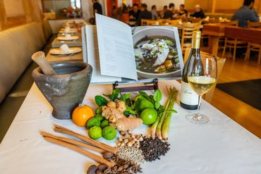 A picture of all herbs and glass of wine 