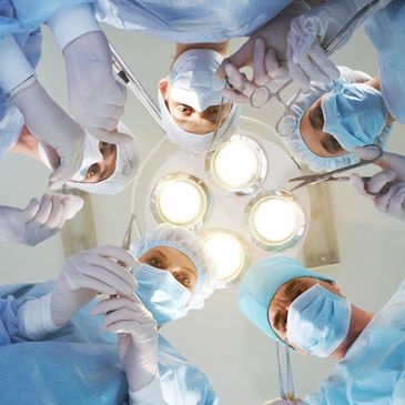 Team of medical professionals performing surgery, view from above