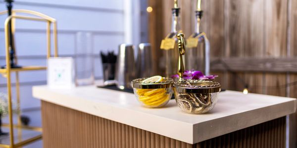 Elegant countertop with decorative bowls and bottles in a cozy setting.