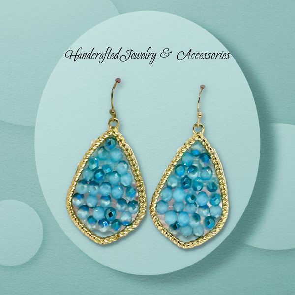 Elegant gold-framed earrings with blue beads, handcrafted jewelry.