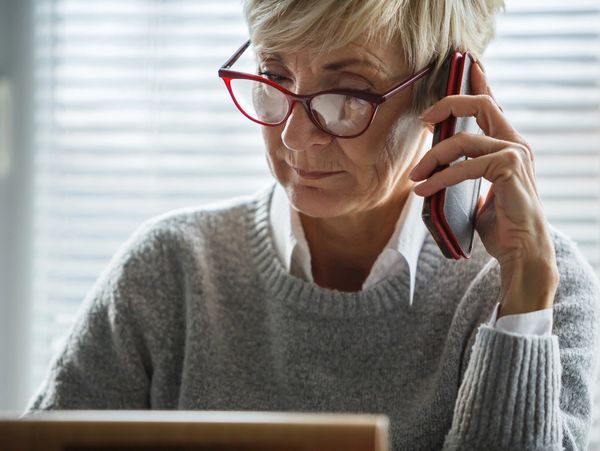 Older lady listening attentively on the phone.