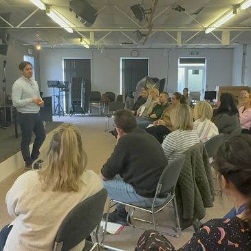 Man giving a presentation to an audience in a room.