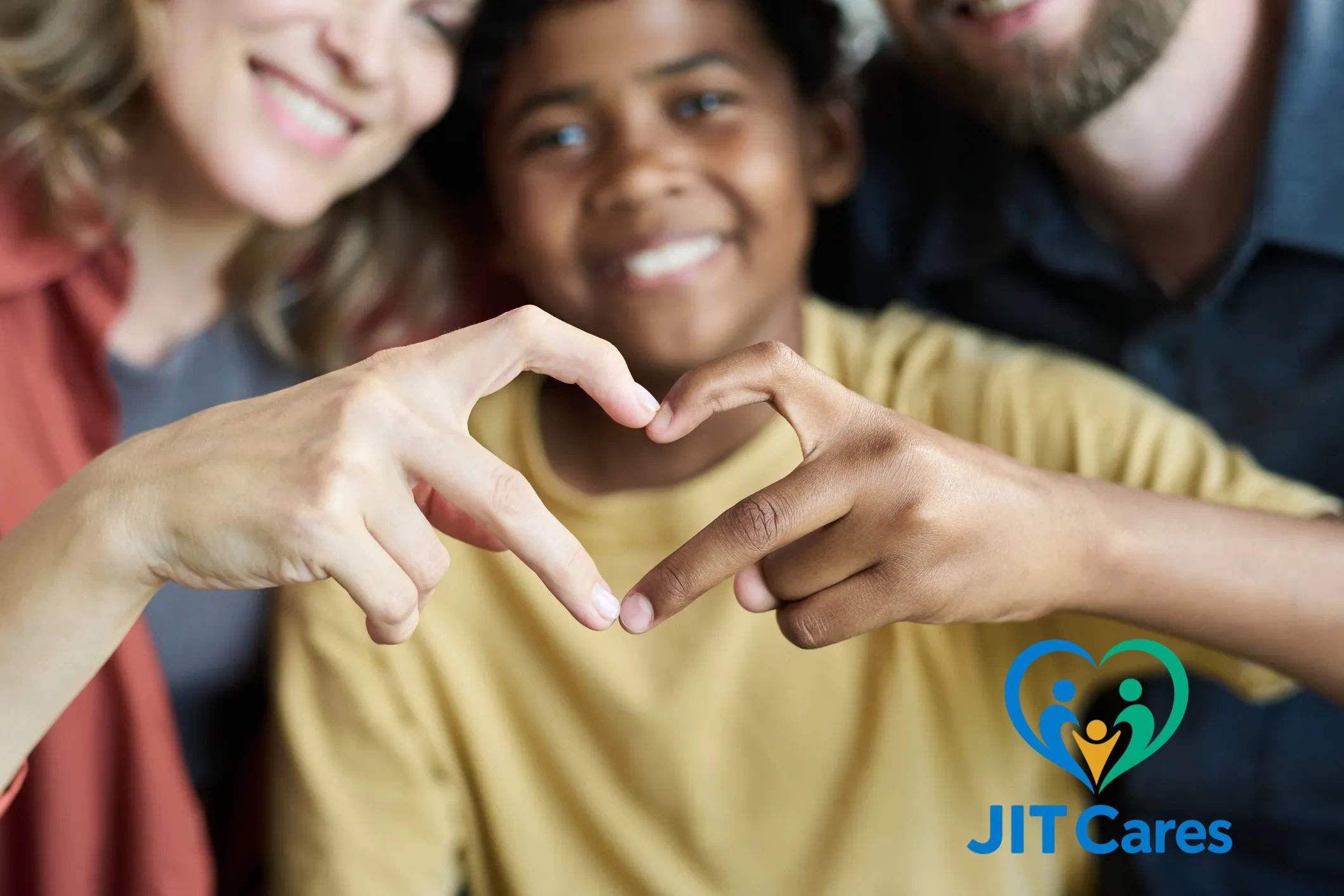 Smiling family making a heart shape with their hands in front of a JIT Cares logo.