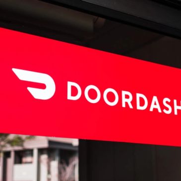 DoorDash logo on a bright red signboard.