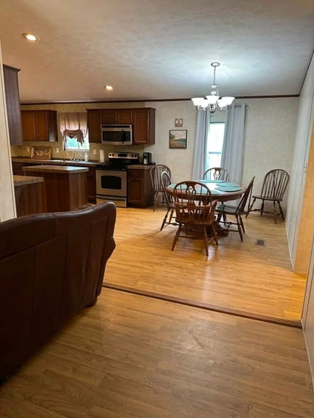 Cozy dining area with wooden furniture and kitchen.