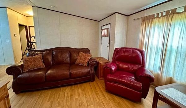 Living room with leather sofa and armchair.