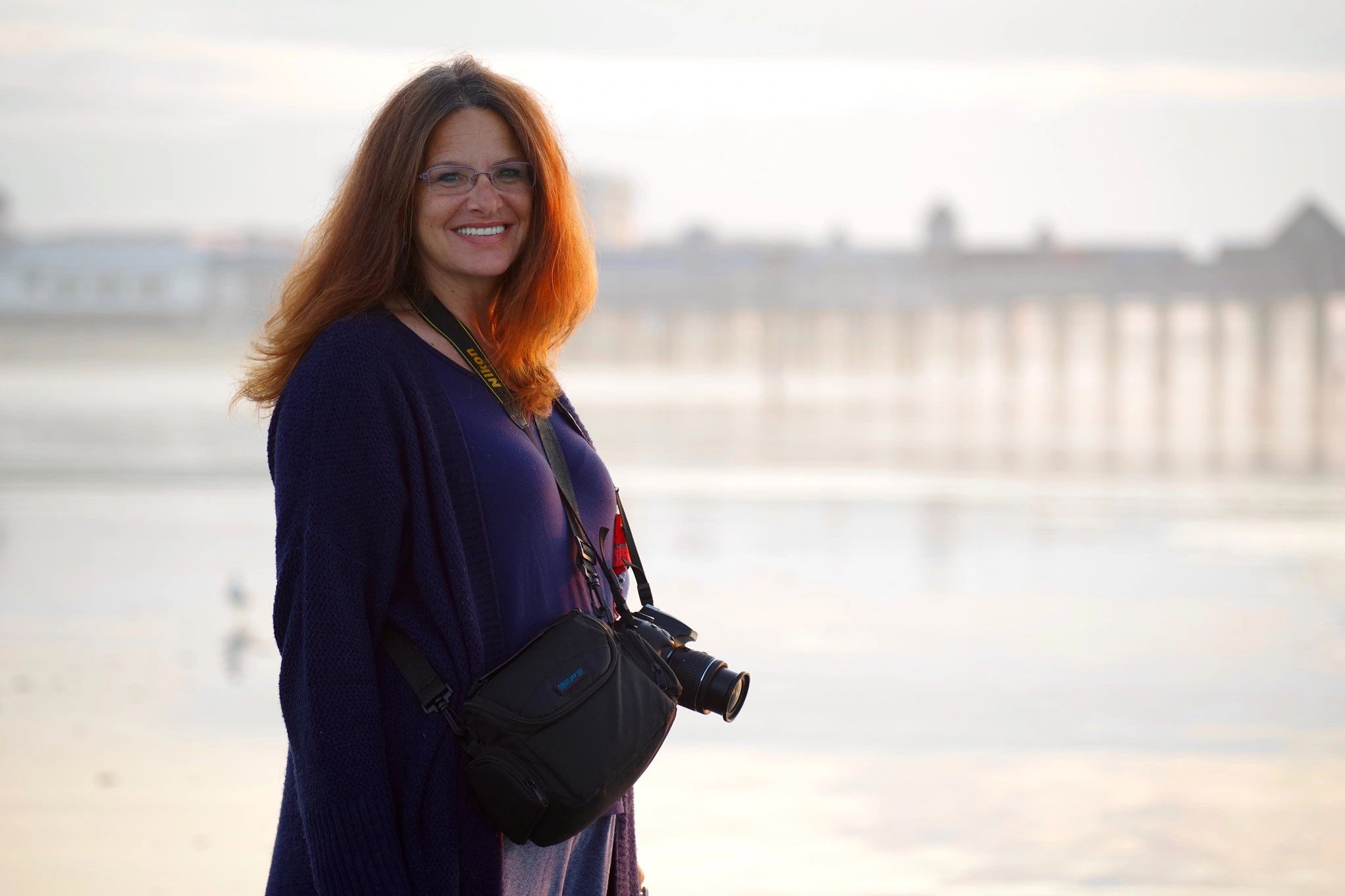 Susan Sue Roulusonis Pione standing on the beach at sunrise with the Old Orchard Beach, Maine Pier i