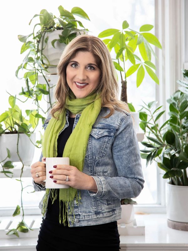 A picture of Stacey Domanico holding a coffee mug