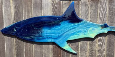 Artistic wooden shark wall decoration with blue tones.