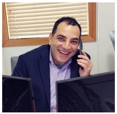 Tony Georr speaking with clients on the phone.