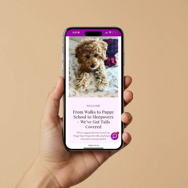 Hand holding phone displaying a puppy care service website with a cute dog image.