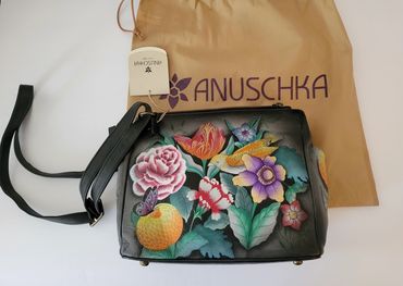 Hand-painted floral leather handbag with Anuschka brand tag and dust bag.