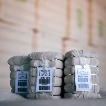 Stacks of silver bars with tags showing weights and serial numbers.