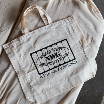 Canvas tote bag with company logo and location.