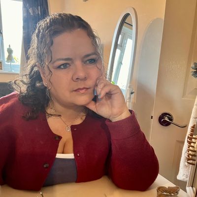 Woman looking thoughtful staying into distance resting on one hand