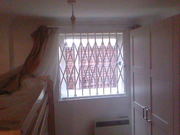Concertina security gates London designed for secure commercial and shopfront protection