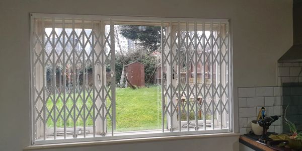 Collapsible security grilles installed in residential areas providing retractable burglar protection