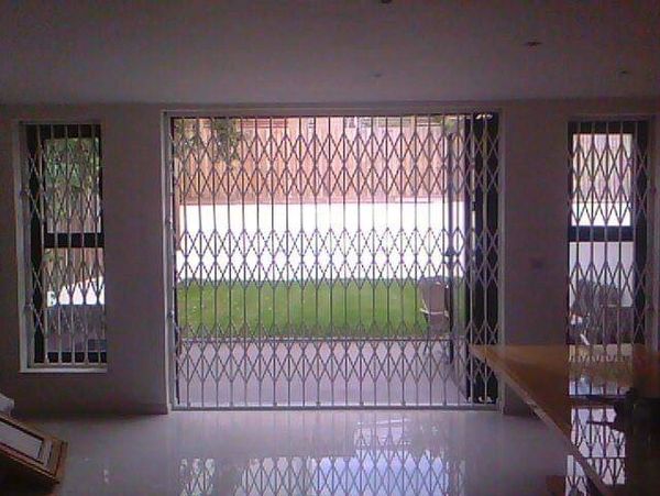 Folding security gates London custom fabricated for strong and discreet property security