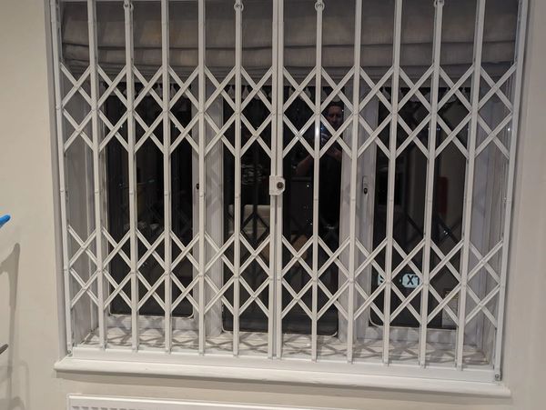 Internal collapsible gates London custom built for secure business and retail protection