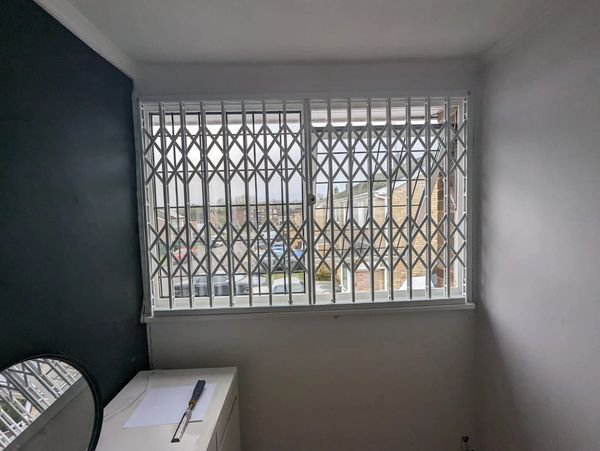 Bespoke collapsible security gates London installed for retail and industrial buildings