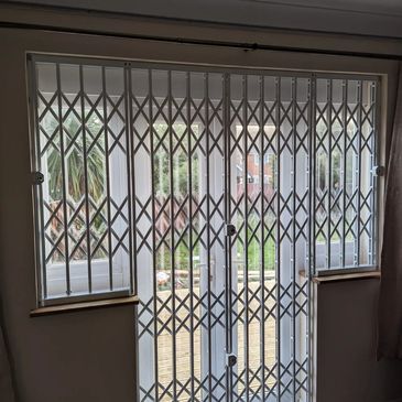 Concertina collapsible gates Northolt installed for shops, warehouses and business security