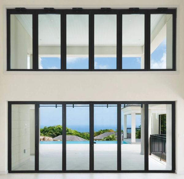 Modern glass doors and windows with ocean view in a bright room.