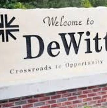 Welcome sign for DeWitt city with a tagline about opportunity.