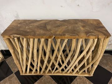 Rustic wooden table with natural log legs and a thick slab top.