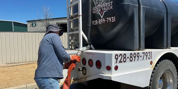 One of Southwest Water Trucks water  distribution specialists filling the truck with potable water