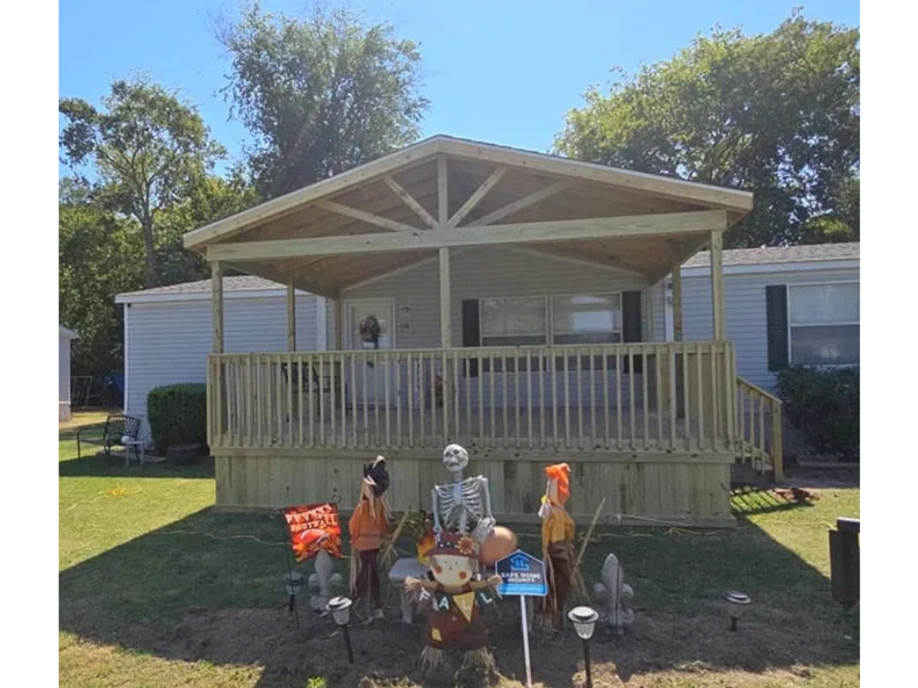 Home with porch and gable  and halloween decor in front.