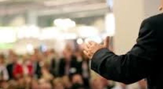 Person giving a speech to an audience.