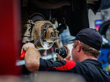 Mechanic Brad Inspecting Car Wheel Hub and Brakes