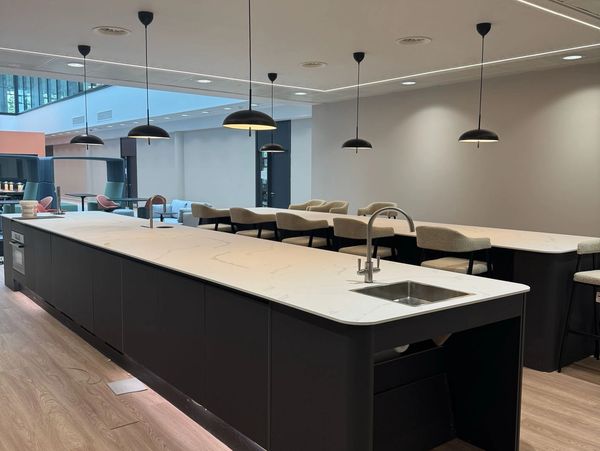 Modern kitchen island with seating and pendant lights.