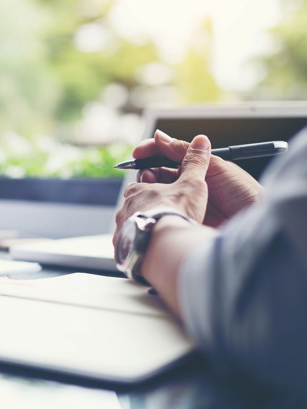 A business person holding a pen